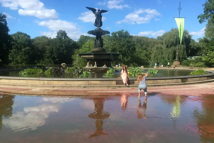 A photo of people taking photos at the flooded Bethesda Fountain